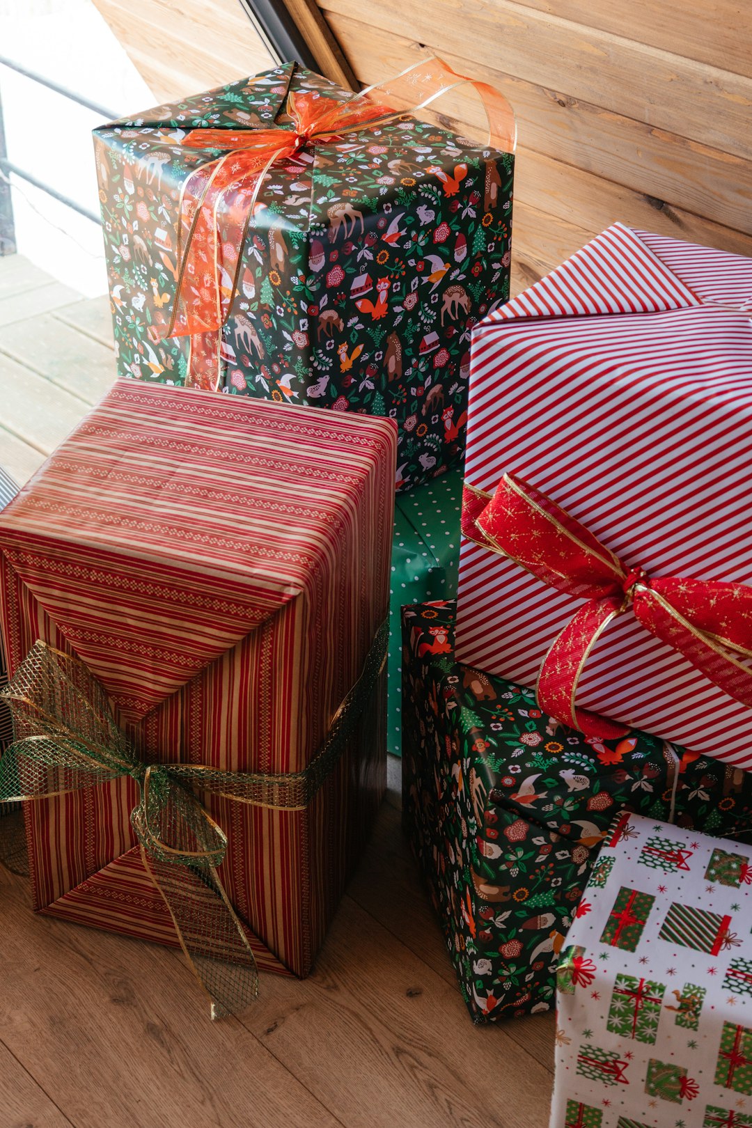 a-group-of-wrapped-presents-sitting-on-top-of-a-wooden-floor-ubsevsw3xhc